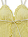 Yellow lace bra with a bow on a white background