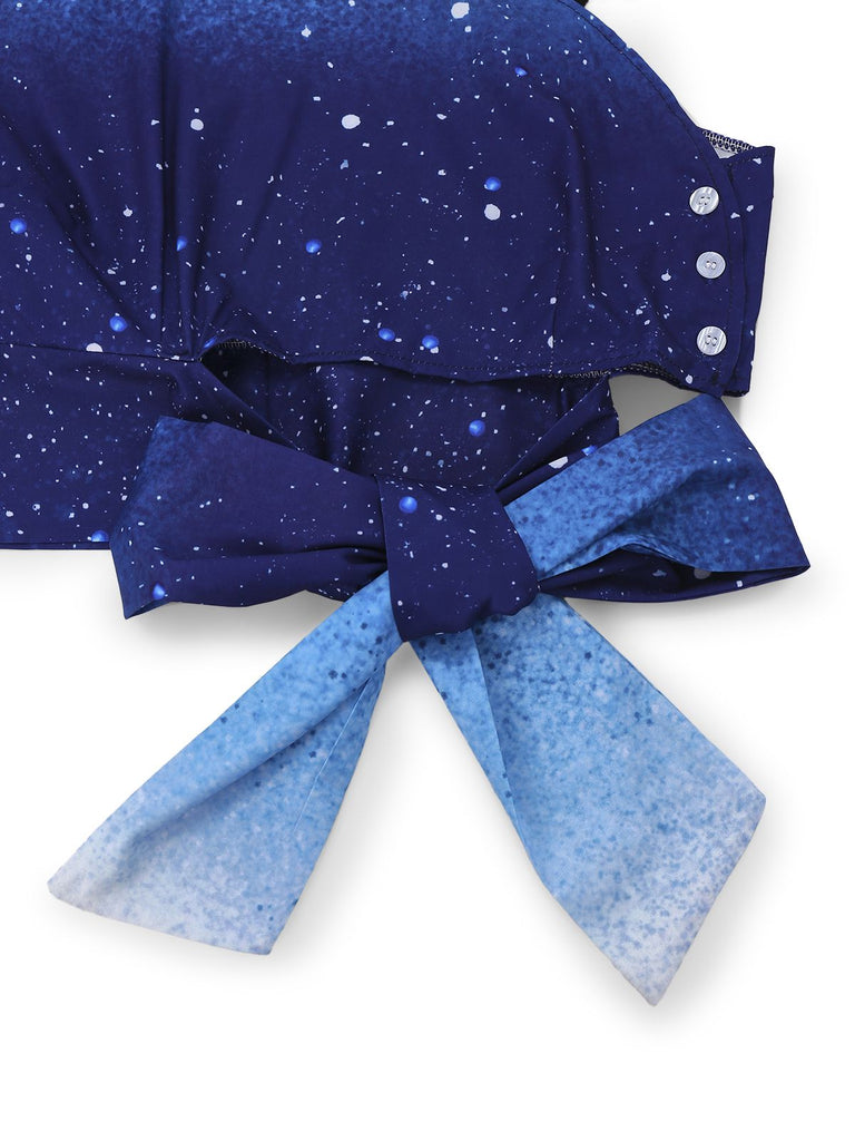 Blue top with star pattern and large bow on a white background