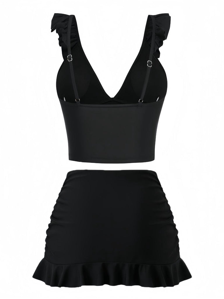 Black two-piece outfit with ruffled top and skirt on a white background