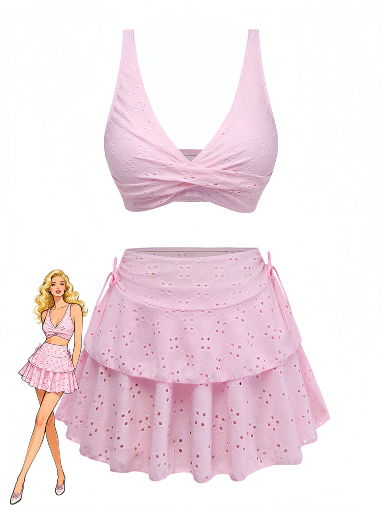 Pink bikini top and skirt set with a doll wearing the outfit on a white background