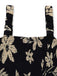Black floral patterned Romper with straps on a white background