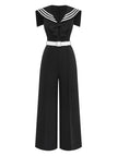 Black jumpsuit with white trim and belt on a white background