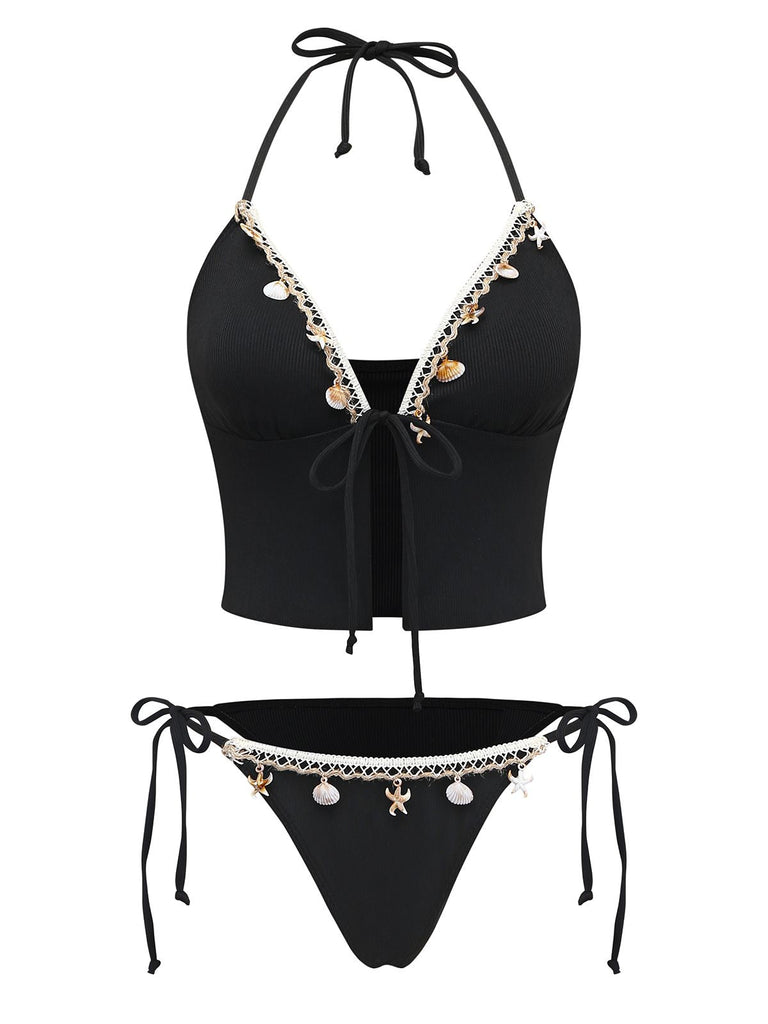 Black bikini set with decorative elements on a white background