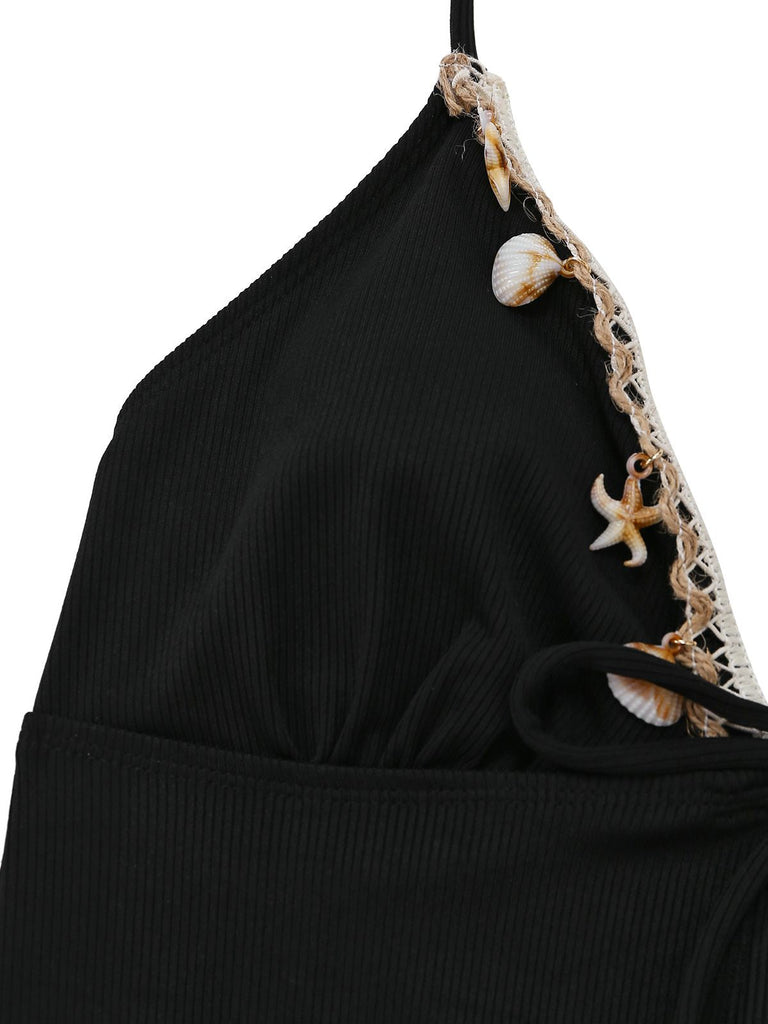 Black halter top with shell and lace details on a white background