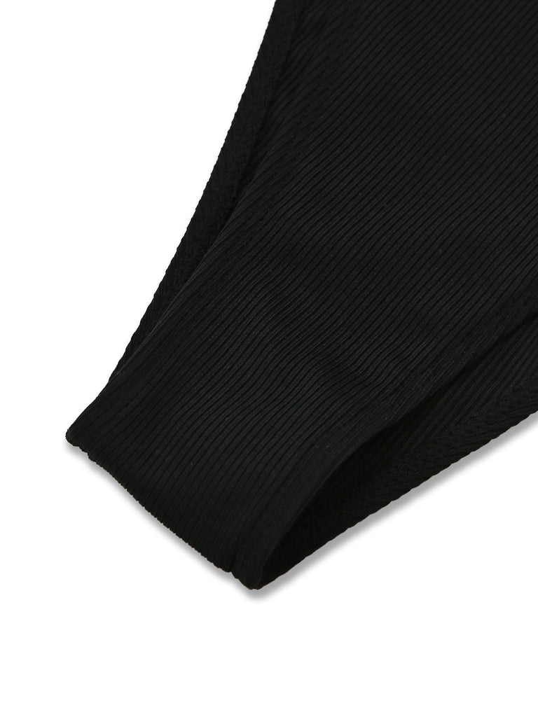 Close-up of a black ribbed fabric on a white background