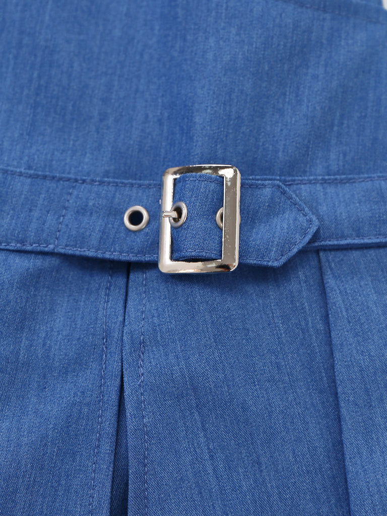 Close-up of a blue denim jacket with a silver buckle.