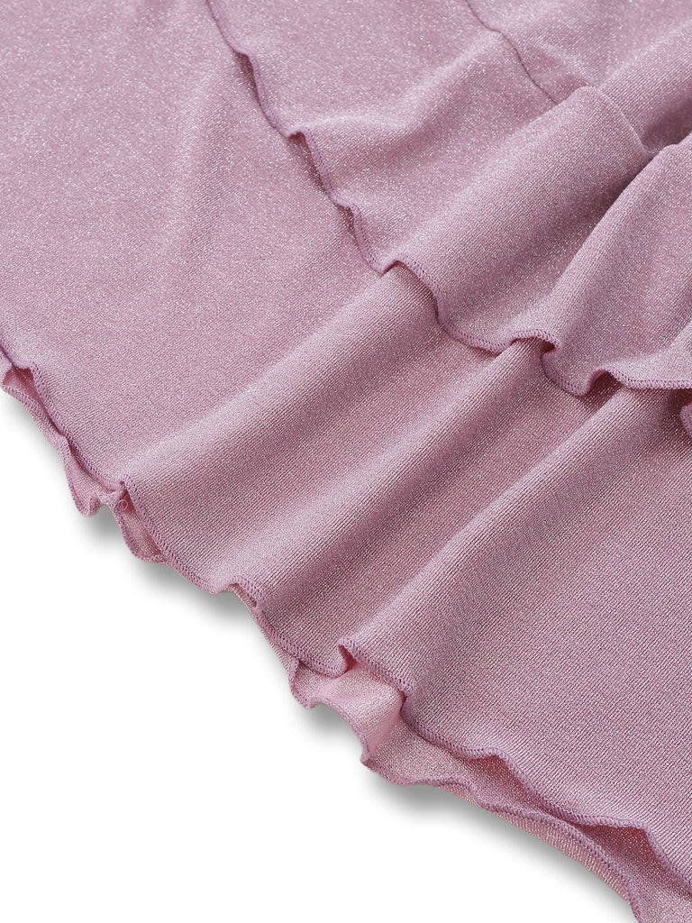 Close-up of pink ruffled fabric on a white background