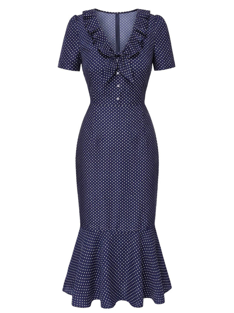 Navy blue dress with white polka dots on a white background