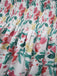 Floral patterned fabric with red, green, and yellow colors on a white background