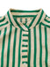 Close-up of a green and beige striped shirt with buttons on a white background
