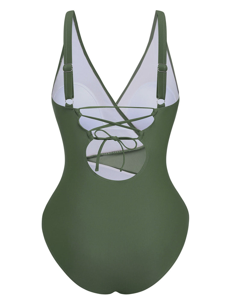 Green swimsuit with criss-cross straps on a white background