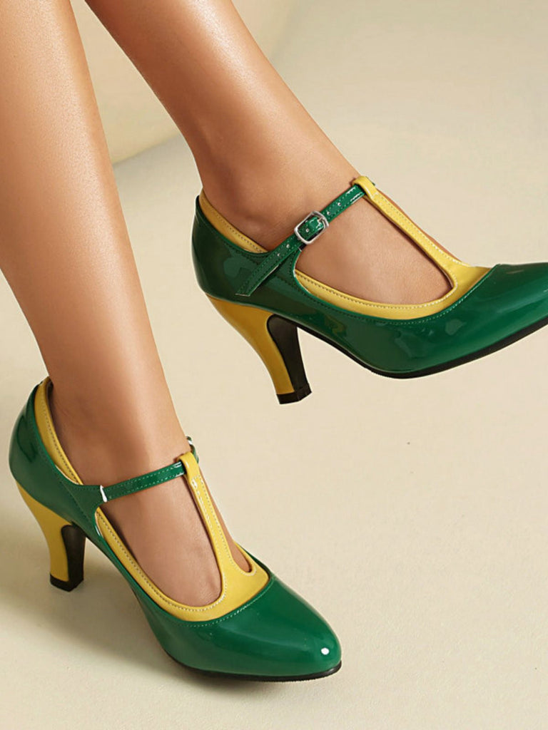 Green and yellow high-heeled shoes on a neutral background