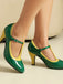 Green and yellow high-heeled shoes on a neutral background