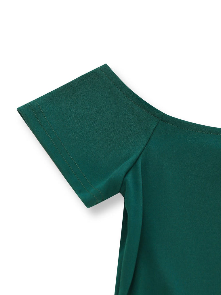Close-up of a green garment with a bow detail on a white background