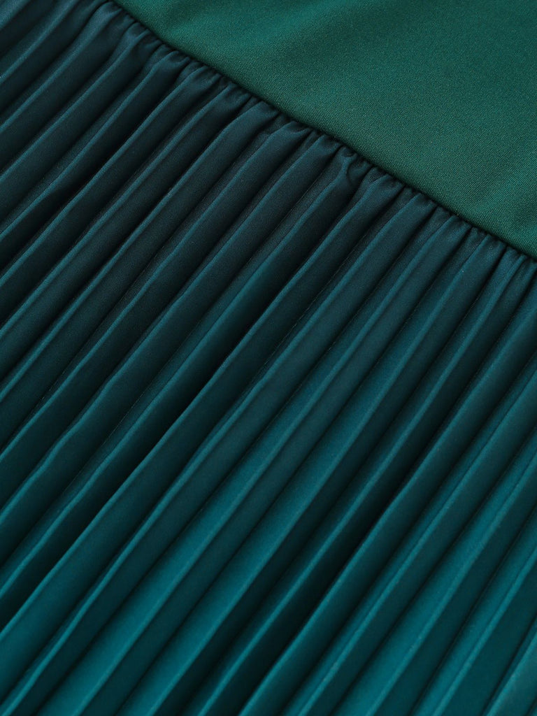 Close-up of pleated teal fabric with a blurred background