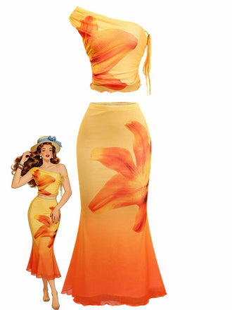 Un ensemble deux pièces éclatant, orné d'un dégradé orange et jaune et d'un grand imprimé floral de lys, comprenant un haut court asymétrique et une jupe longue assortie de style sirène.