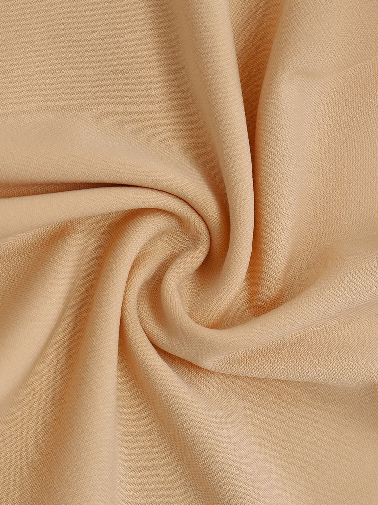 Combinaison beige à dos nu froncé et ornée perles jambes larges années 60