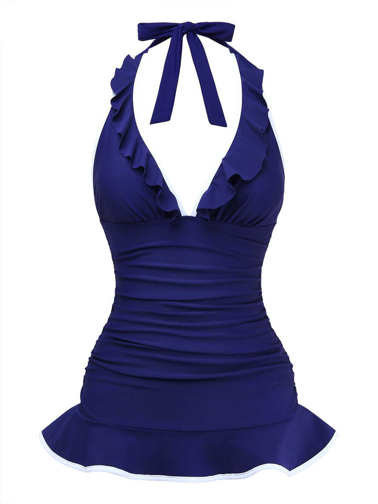 Vue de face du maillot de bain dos nu à volants, version bleu marine, mettant en valeur le tissu froncé gainant.