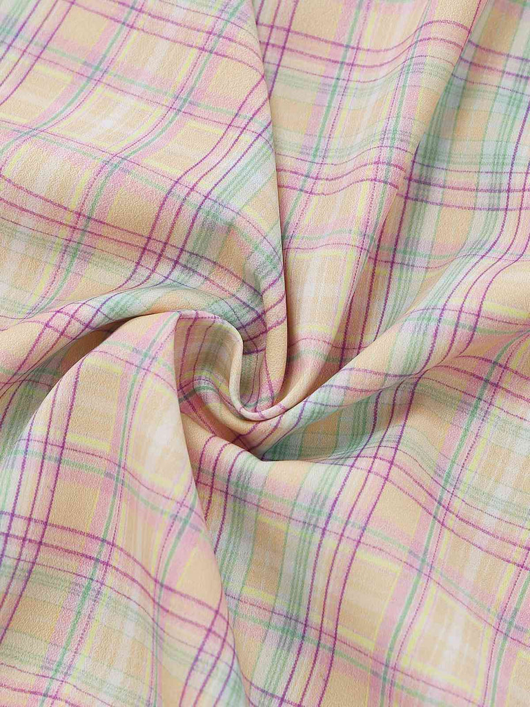 Pastel plaid swing dress with ruffled bow details and sweetheart neckline for 1950s vintage styling