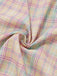 Pastel plaid swing dress with ruffled bow details and sweetheart neckline for 1950s vintage styling