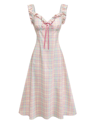 Pastel plaid swing dress with ruffled bow details and sweetheart neckline for 1950s vintage styling