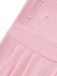 Close-up of a pink jumpsuit with pearl embellishments on a white background