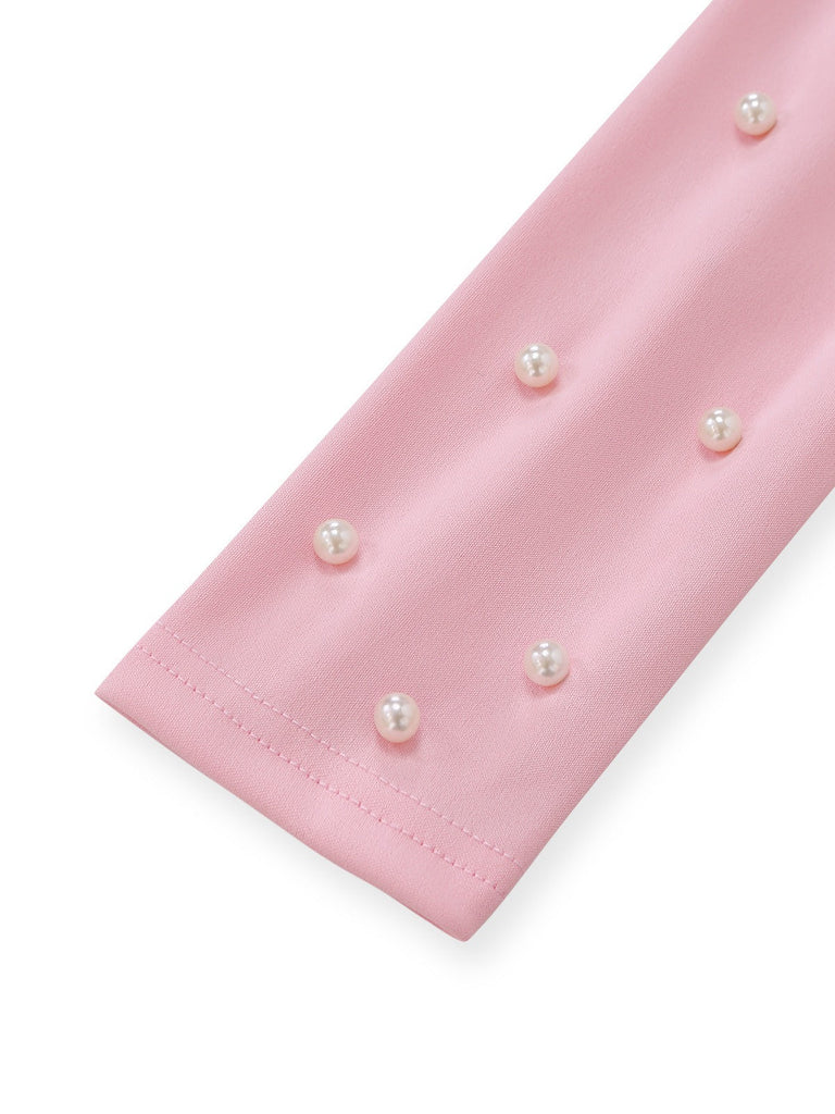 Pink fabric with pearl embellishments on a white background