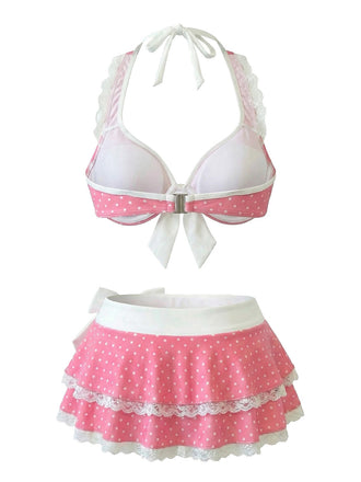 White bikini top with pink polka dot trim and matching skirt on a white background