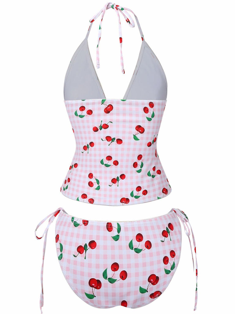 Two-piece swimsuit with cherry pattern on a white background
