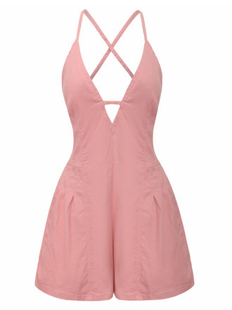 Pink romper with criss-cross straps on a white background