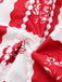 Close-up of red and white floral fabric with a necklace.