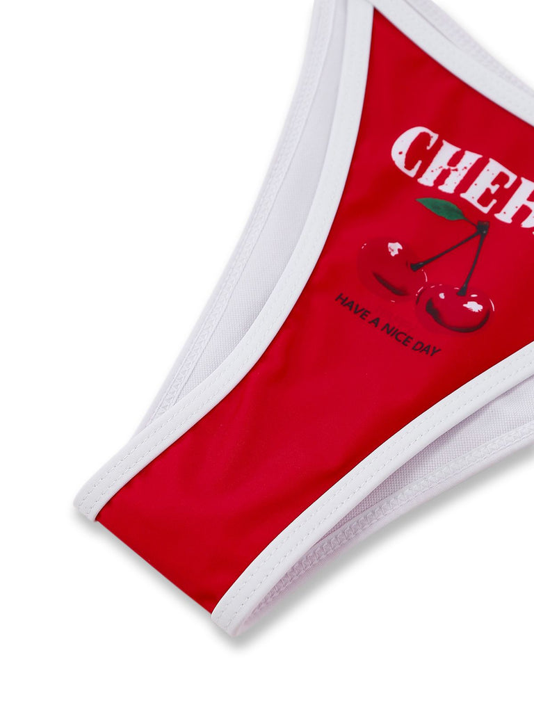 Red towel with white border and cherry design on a white background