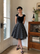 Robe évasée noire maille pois manches courtes et ceinture années 50