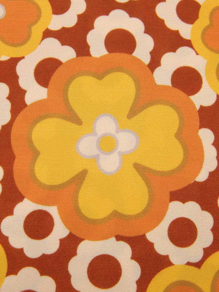 Haut sans manches à col noué et motif floral des années 1960