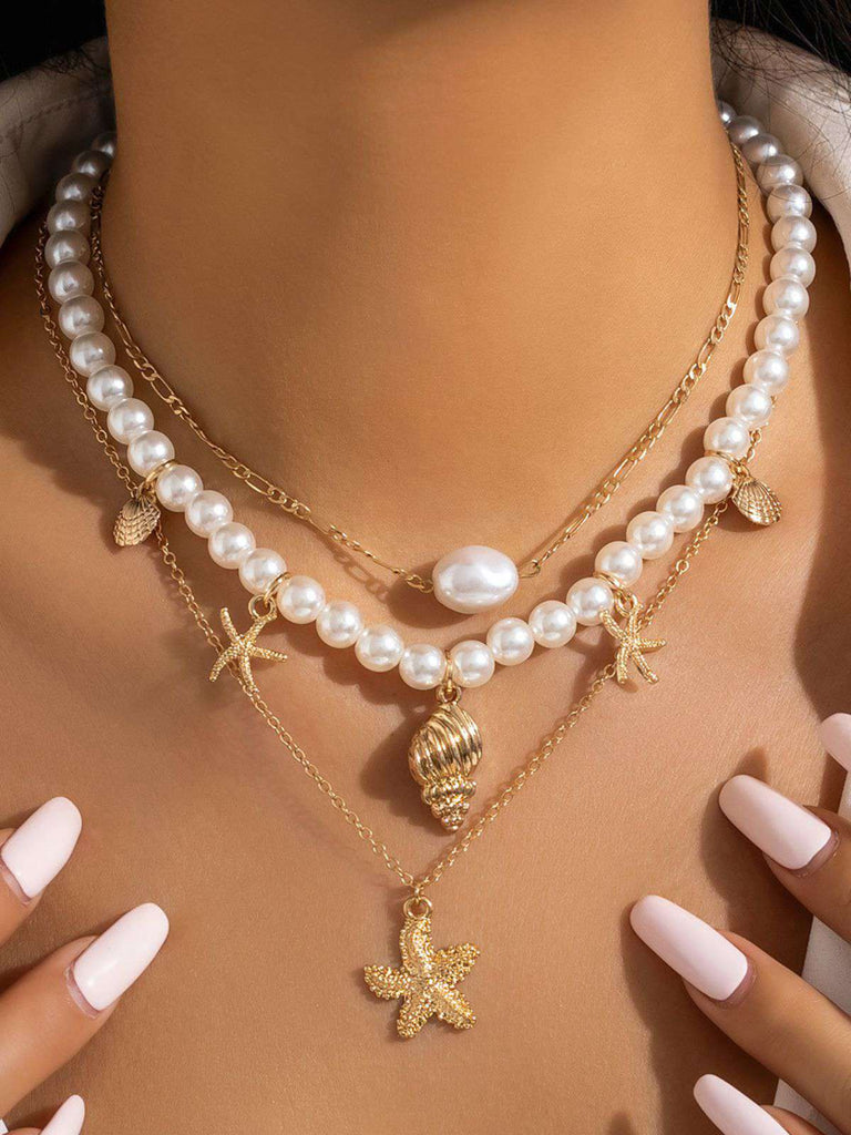 Collier chaîne superposée en perles coquillages et étoiles de mer