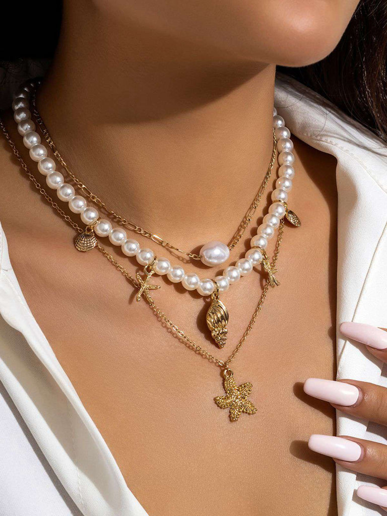 Collier chaîne superposée en perles coquillages et étoiles de mer