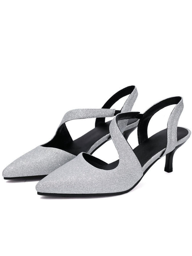 Pair of silver glittery kitten heel shoes on a white background