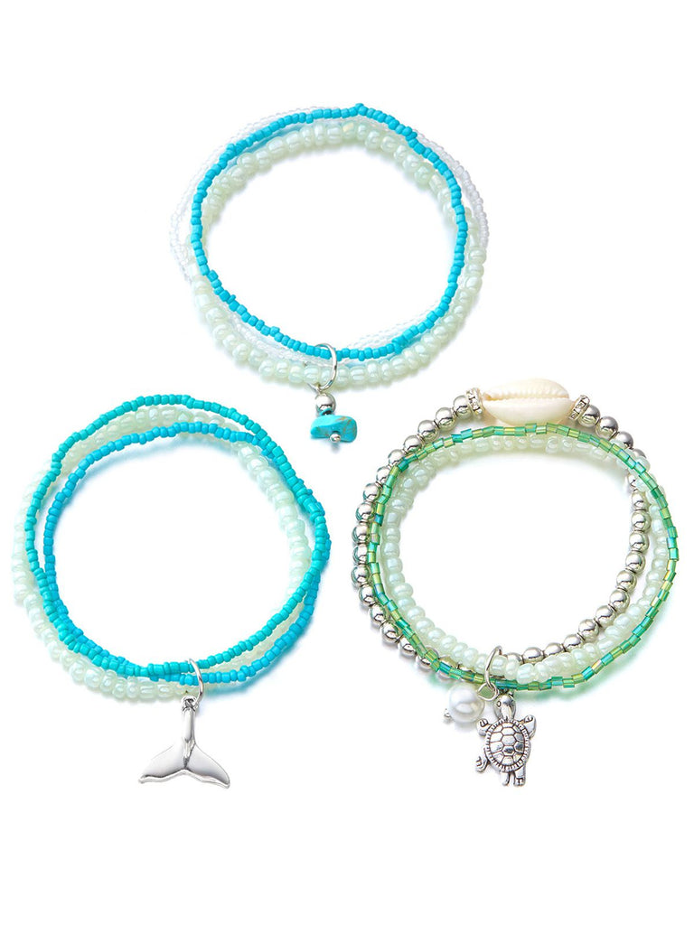 Three beaded bracelets with charms on a white background