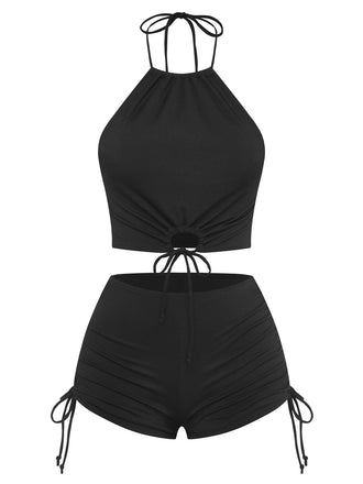 Classic black two-piece swimsuit featuring halter neck design and ruched fabric details, ideal for retro beach style and summer holidays