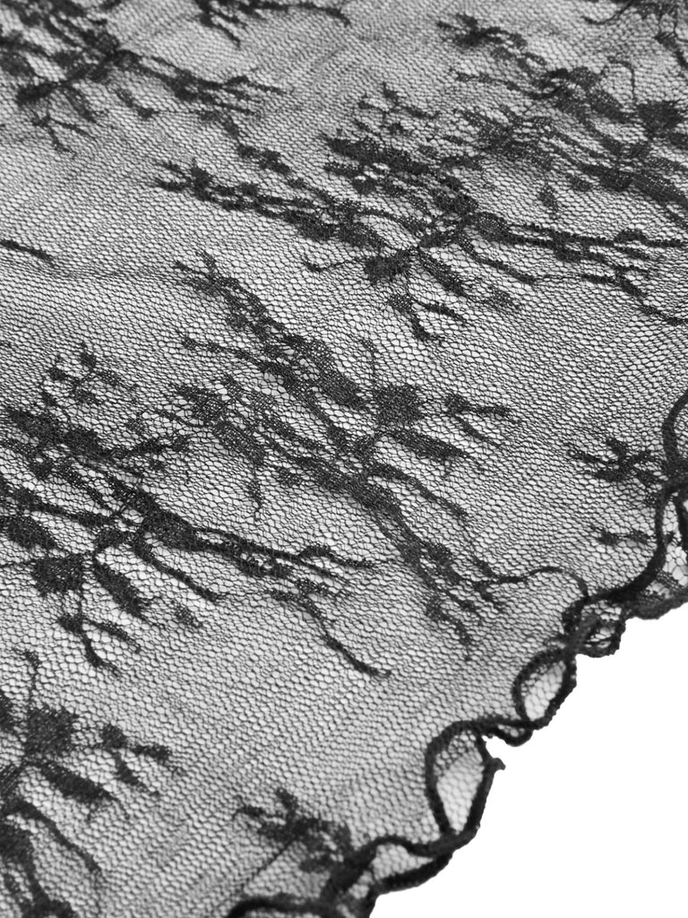Close-up of the delicate sheer floral lace fabric and scalloped edge detail on the long-sleeve top.