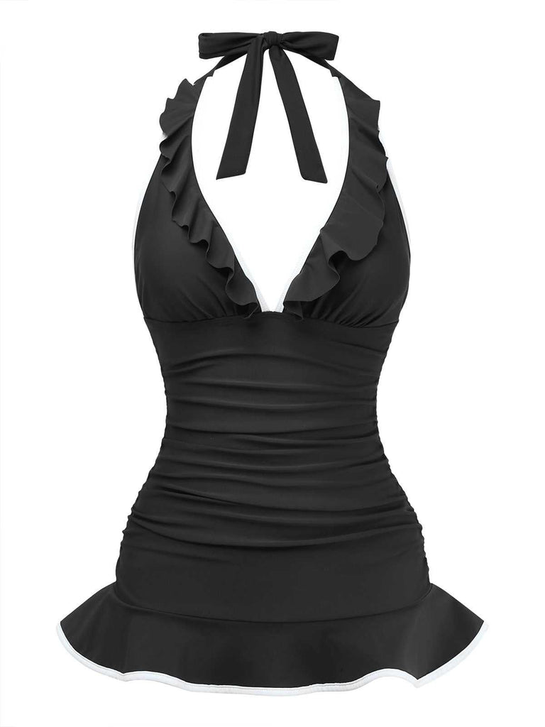 Front studio shot of the black halter swimsuit featuring a deep V ruffled neckline and a flattering skater-style skirted hem.