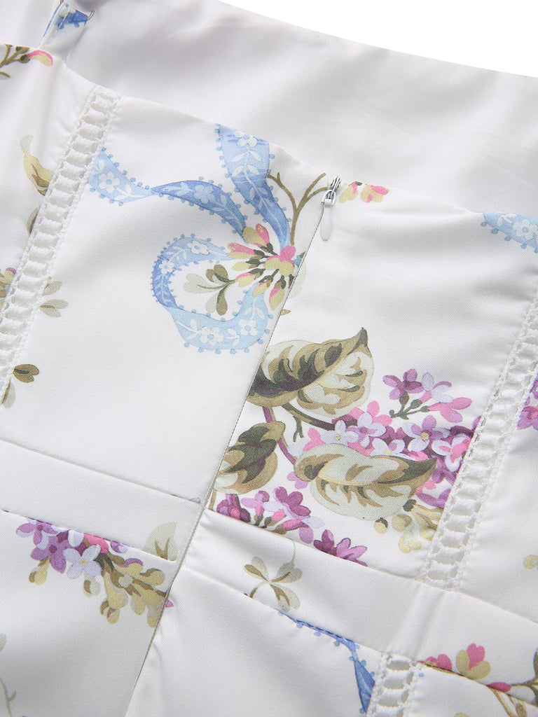 Macro shot of the fabric detail highlighting the intricate blue ribbon and purple floral bouquet pattern.