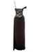 Side-angled view of the brown maxi dress showcasing the single spaghetti strap and off-the-shoulder draped sleeve.