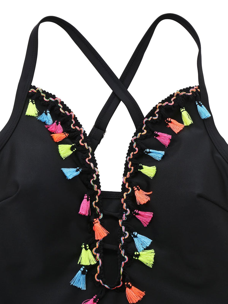 Close-up of the vibrant, multi-colored tassels and intricate embroidery along the deep V-neckline.