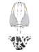 Back view of the black and white cow print bikini showcasing the tie closures and gold chain strap detailing.