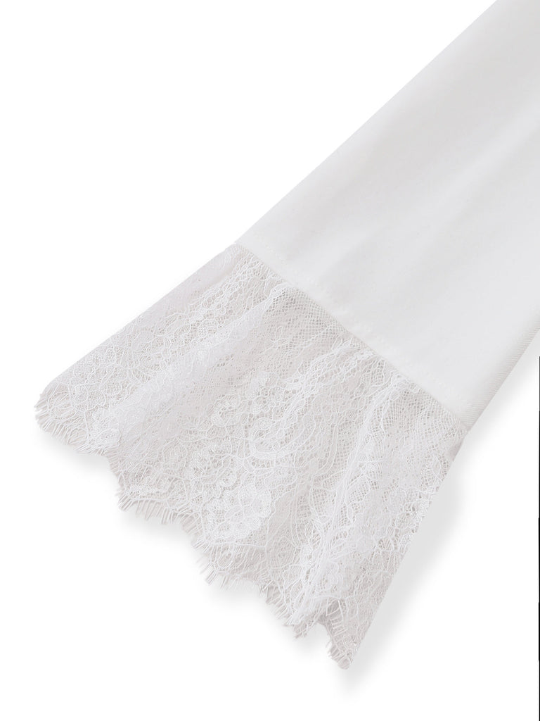 Detail shot of the intricate white floral lace trim attached to the sleeve cuff of the blazer dress.