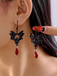 Boucles d'oreilles pendantes gothiques chauve-souris noire et cristal rouge