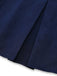 Close-up of the vertical pleat construction near the skirt's hemline.
