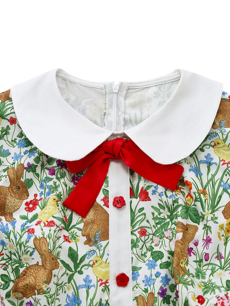 Close-up of the white Peter Pan collar featuring a decorative red velvet-style bow and red buttons.