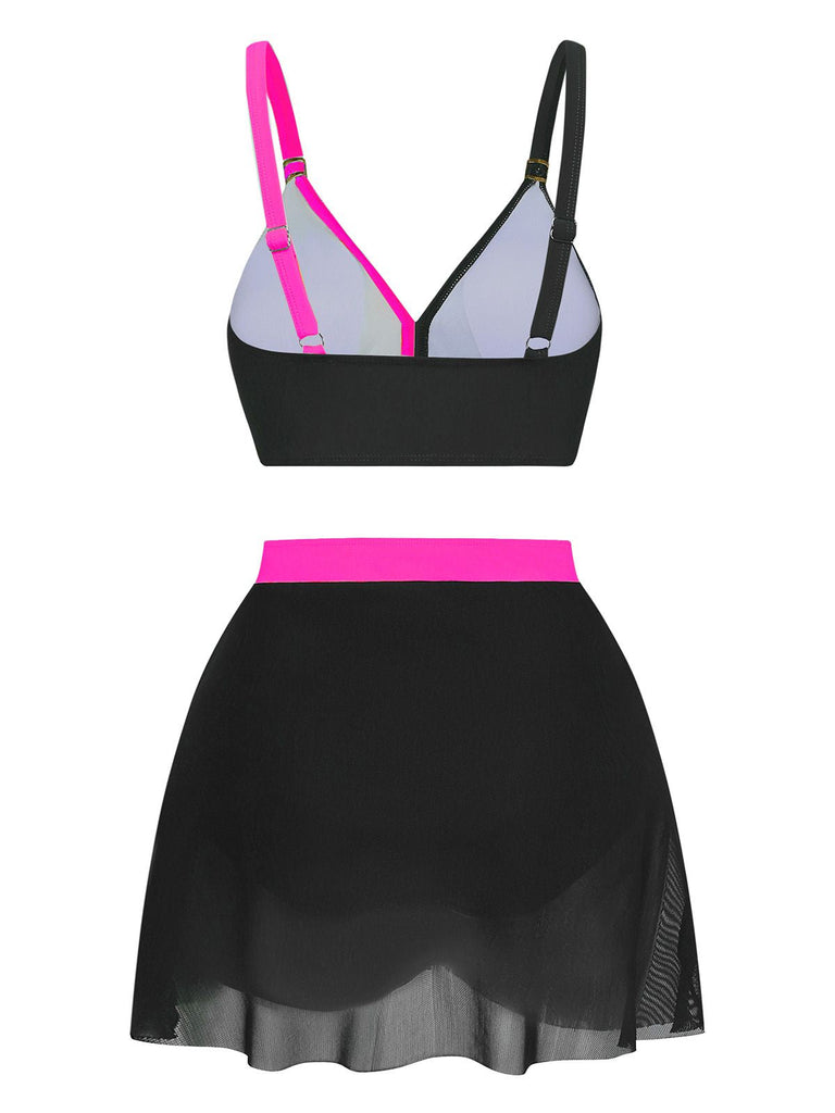 Black and pink bikini set with a sheer black skirt on a white background